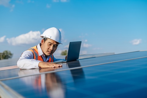 Young Asian technician man checking operation photovoltaic solar
